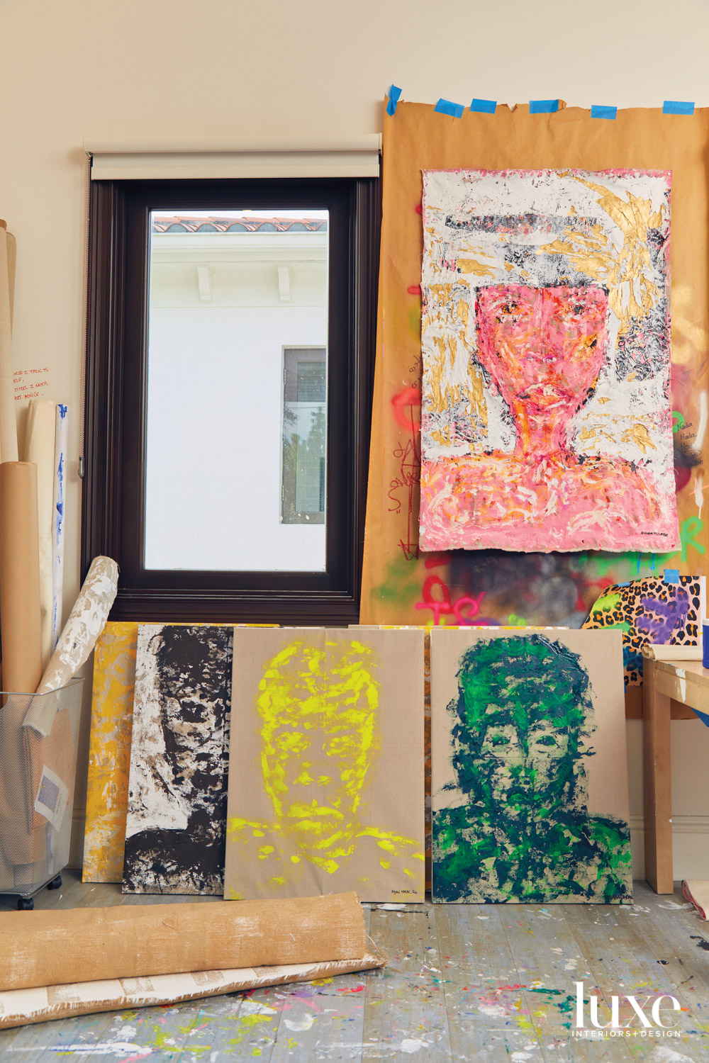 collection of aidan marak portraits displayed in her studio