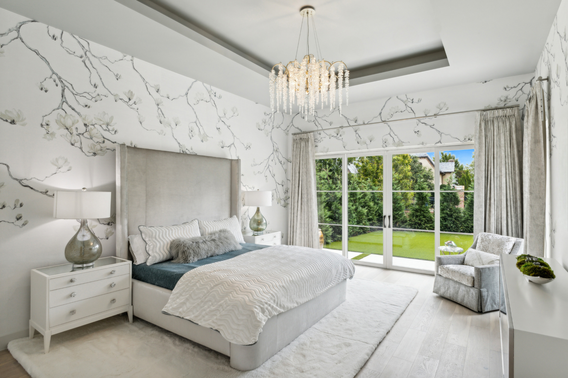 Ethereal Alley, Southlake: A beautifully designed bedroom by Susan Semmelmann Interiors with a grand bed and a shimmering chandelier, exuding comfort and luxury. 