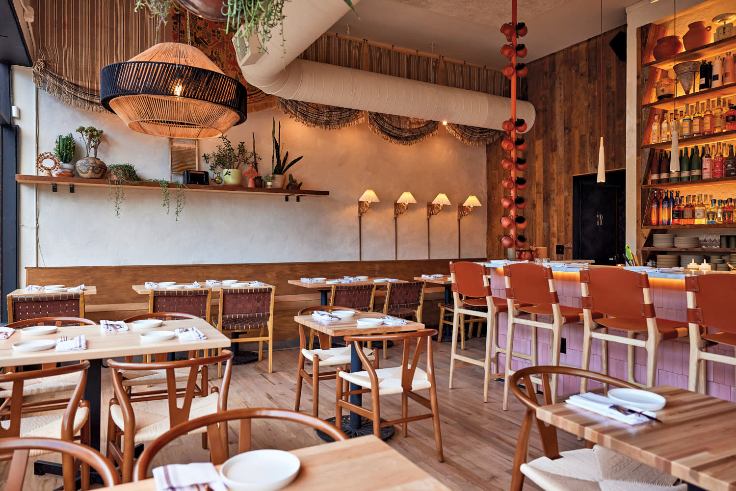 Inside of Alma Fonda Fina dining area with tables and chairs