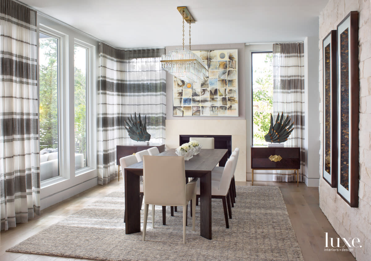 dining room with limestone fireplace and black oak table