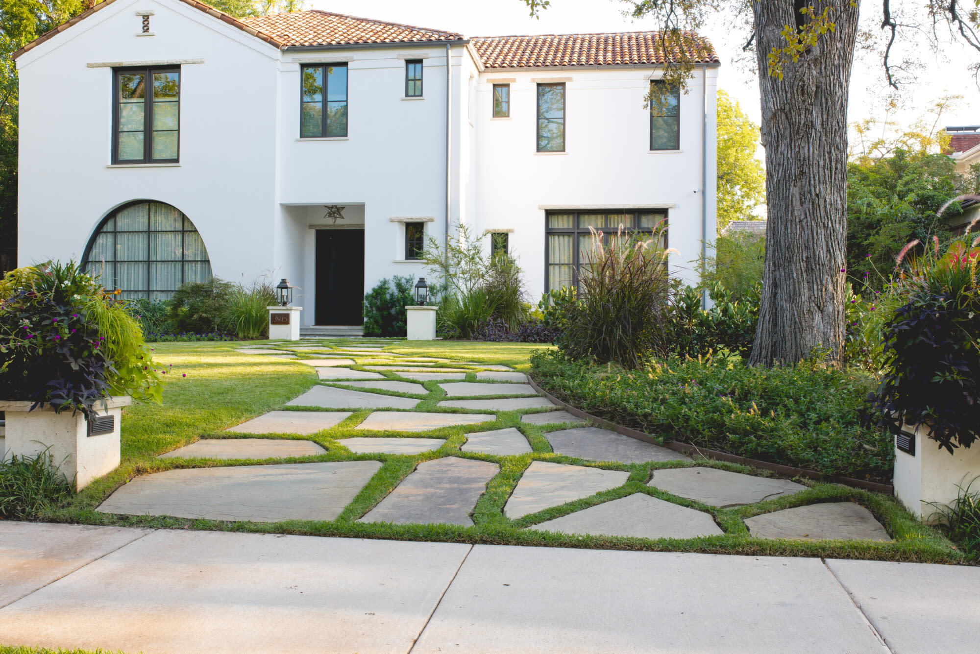 Front yard with stone walkway and manicured lawn