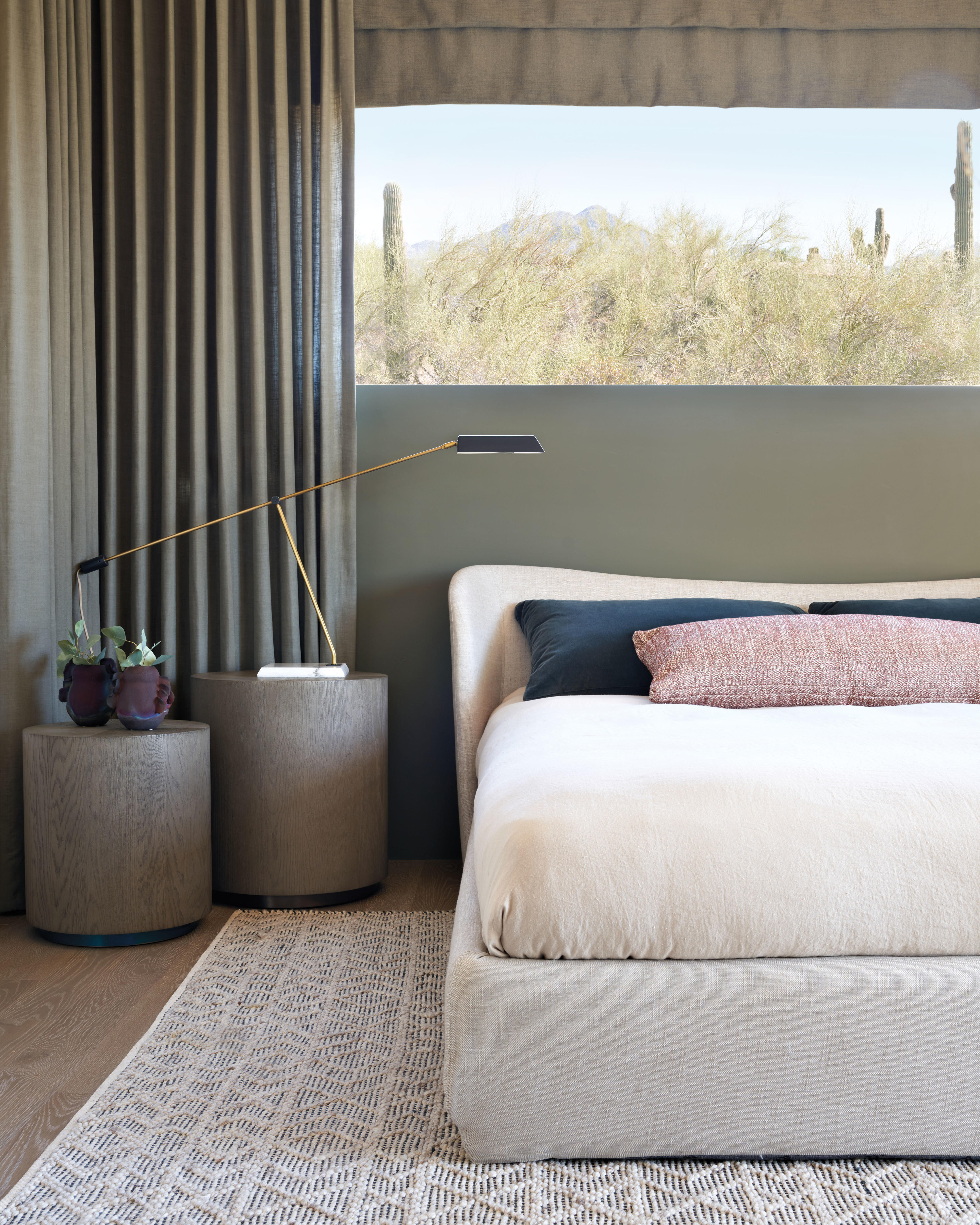 primary bedroom with a horizontal picture window above the bed showing views of the desert