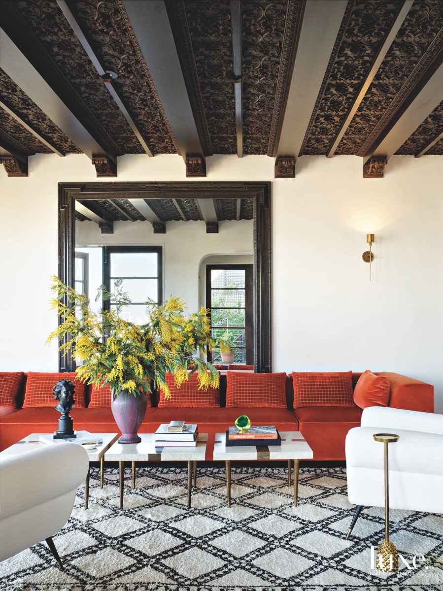 mediterranean living room red couch detailed ceiling