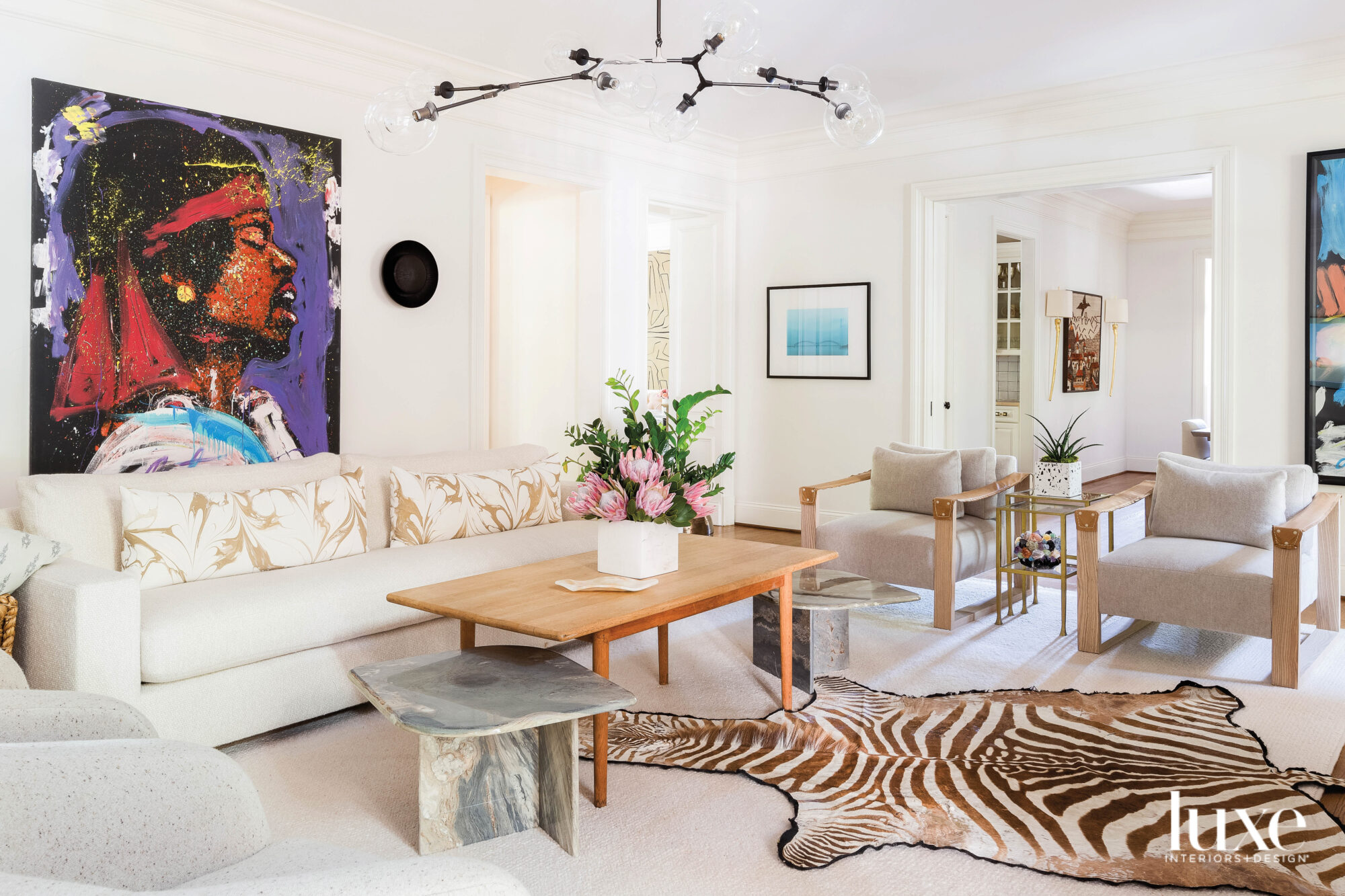 White living room with zebra print rug and bold abstract painting