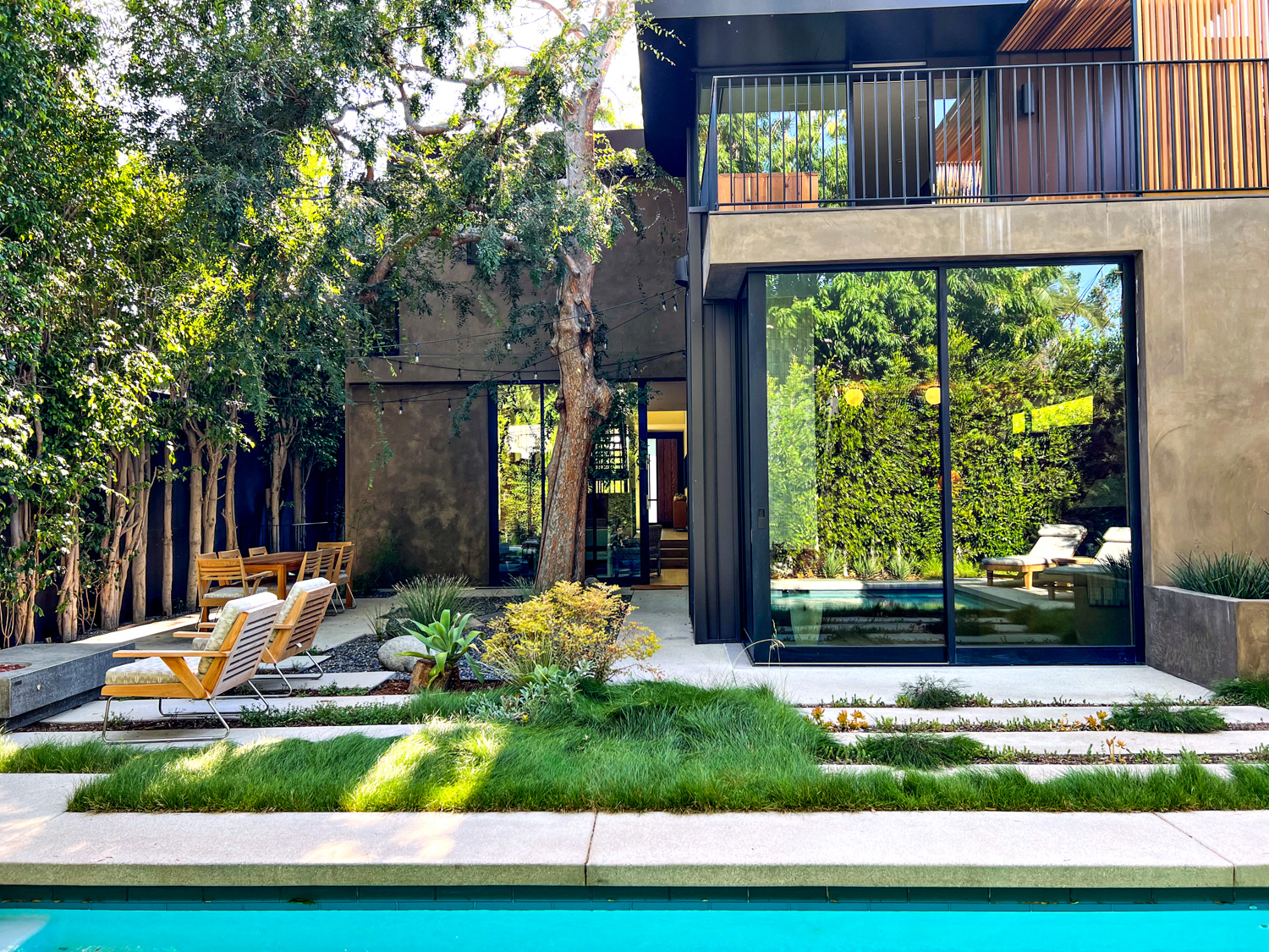 the backyard of a California home with architectural elements and native plants