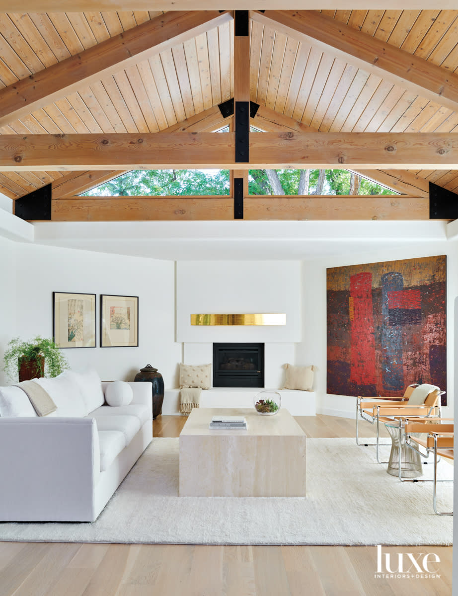 living room with bright colored art and high wooden ceilings