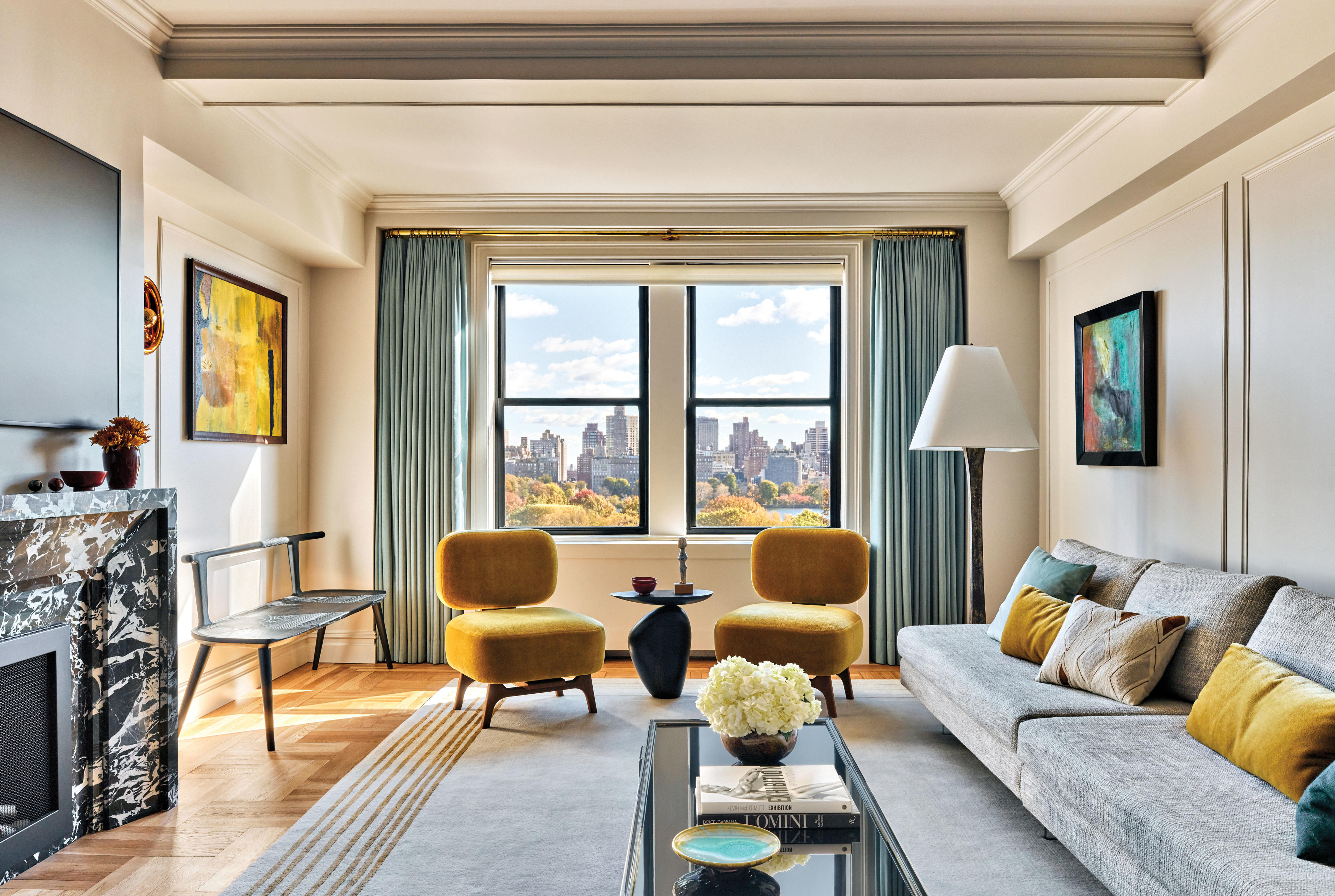 chic living room with pops of yellow and views of NYC out the window