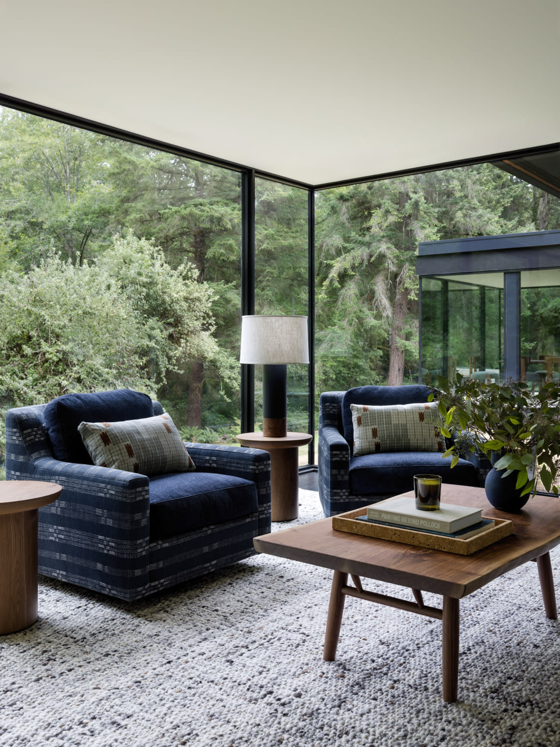 modern office with blue armchairs and glass walls