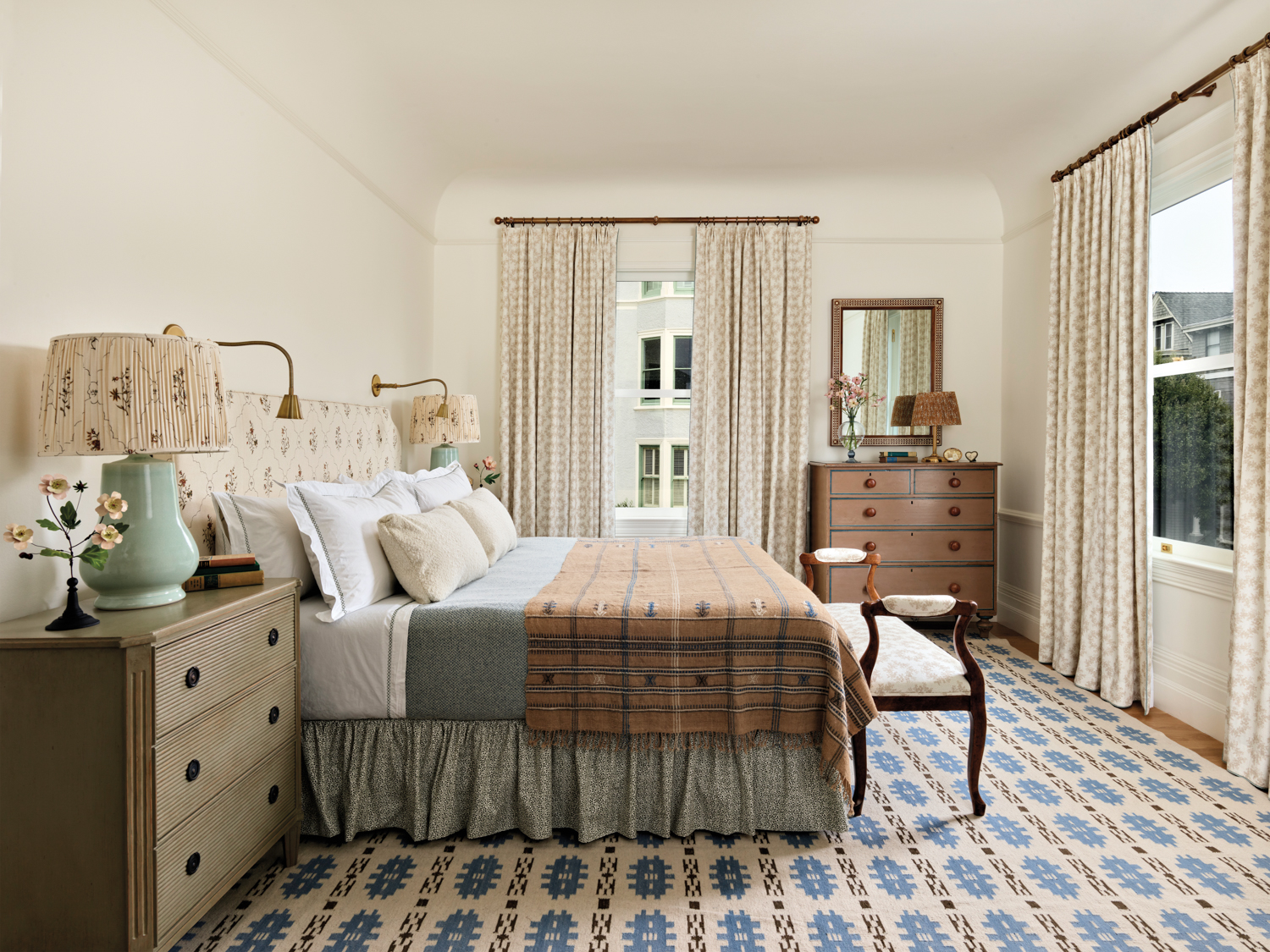 primary bedroom with blue and white patterned carpet