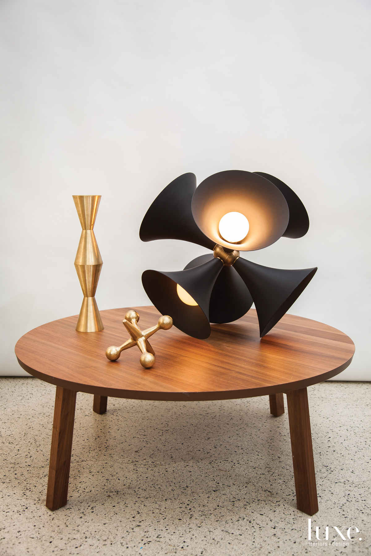 A domed black light fixture glows on a wooden table.