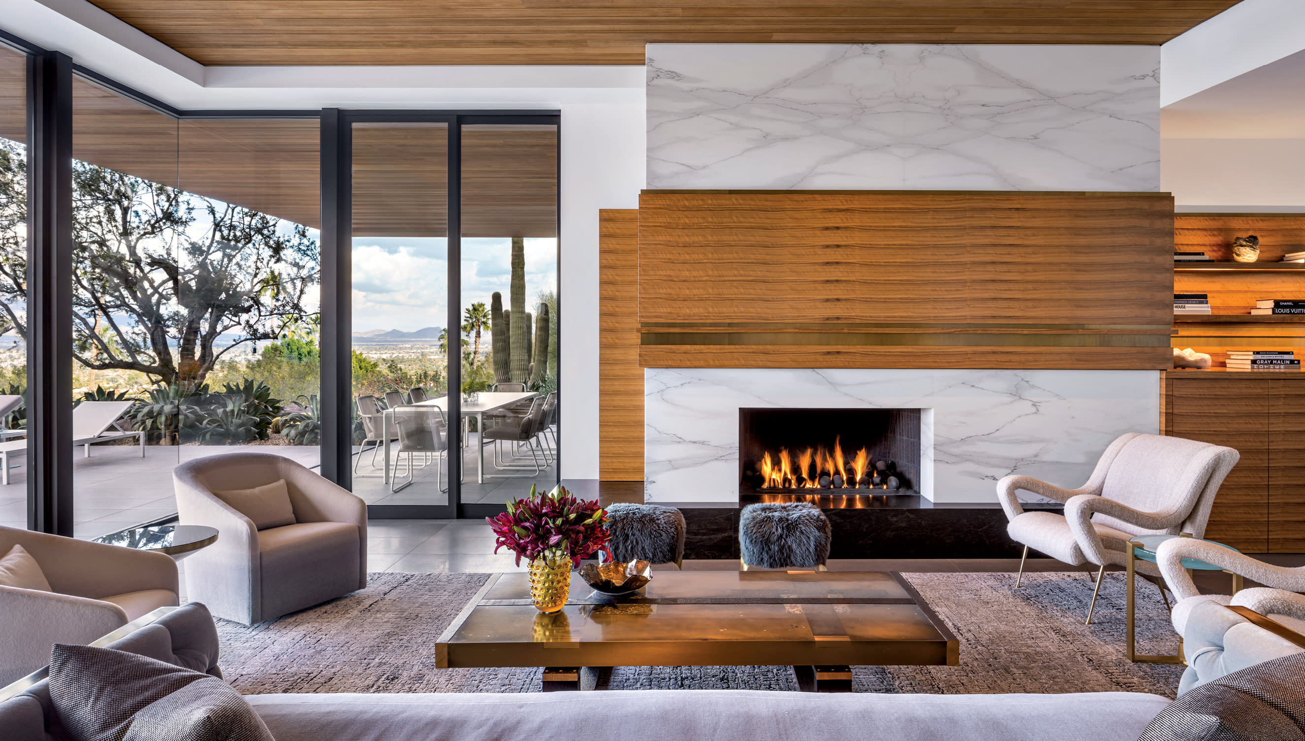 contemporary living room with a marble fireplace and sliding walnut panel