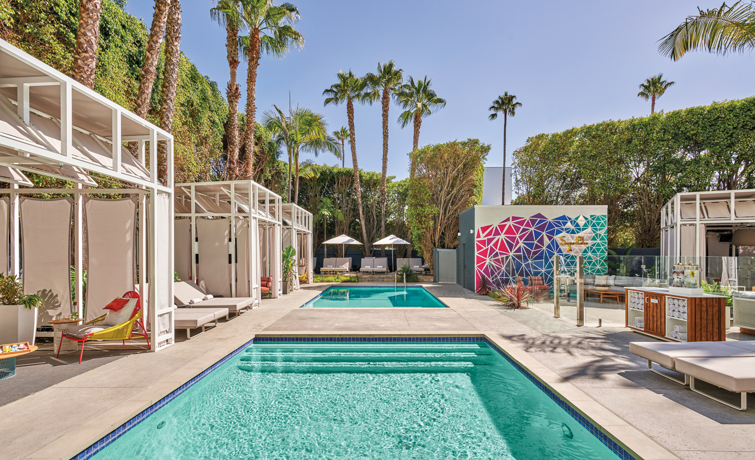 Exterior with swimming pool, art murals and palm trees