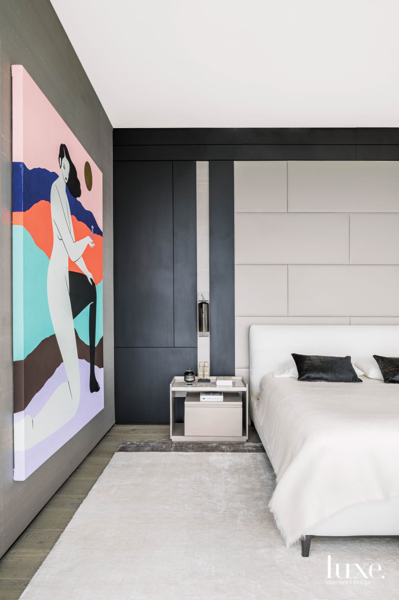 Master bedroom with colorful artwork and black elm wall