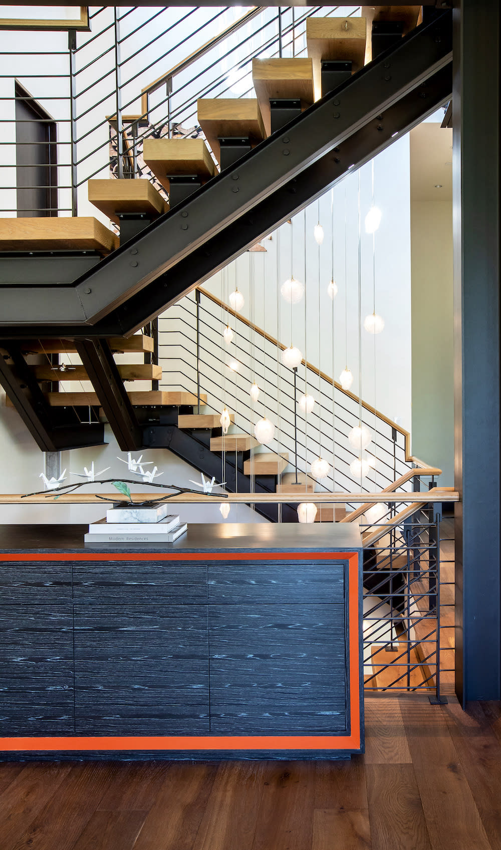 Metal and wood open staircase with statement lighting