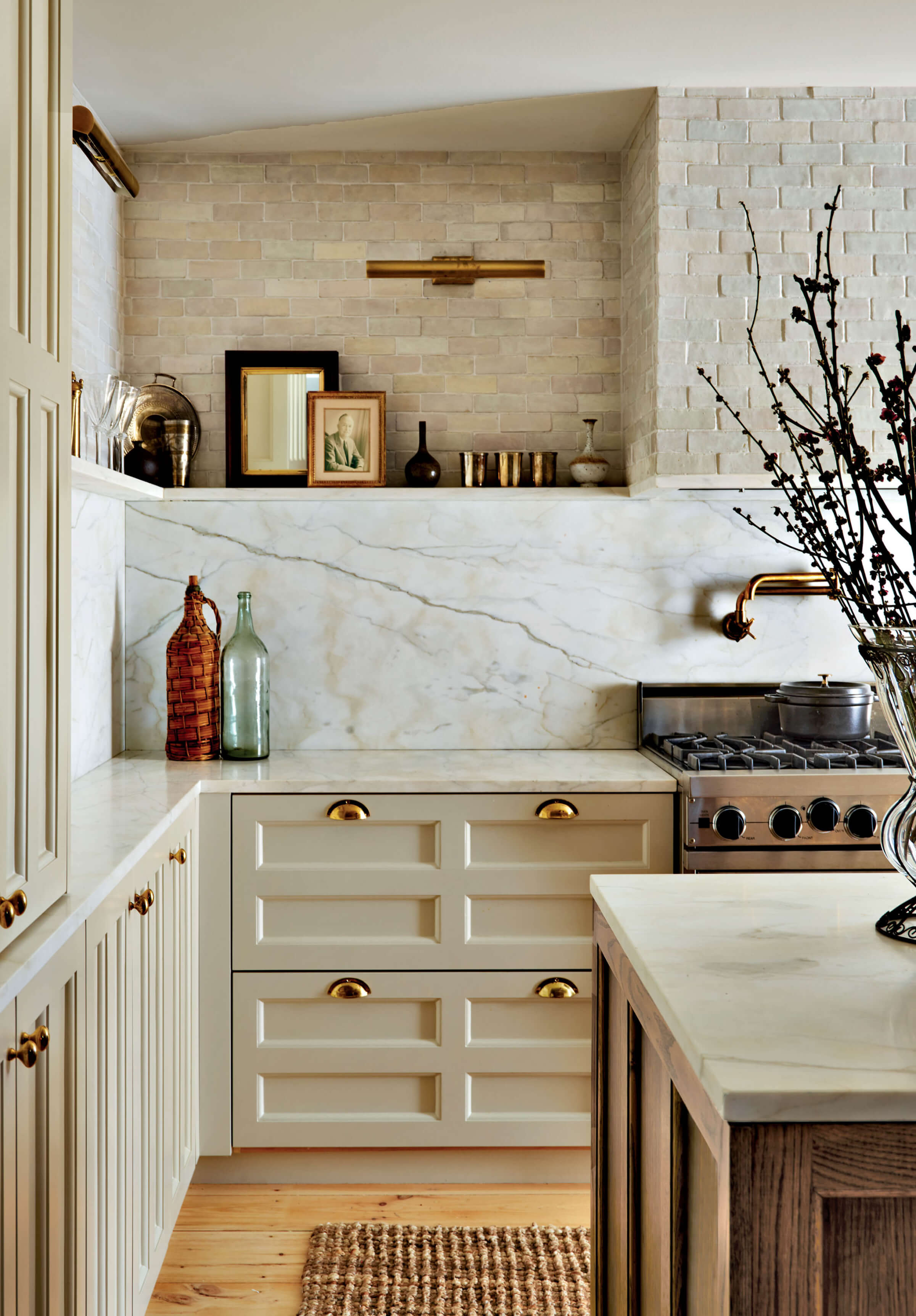 taupe kitchen cabinetry with gold hardware