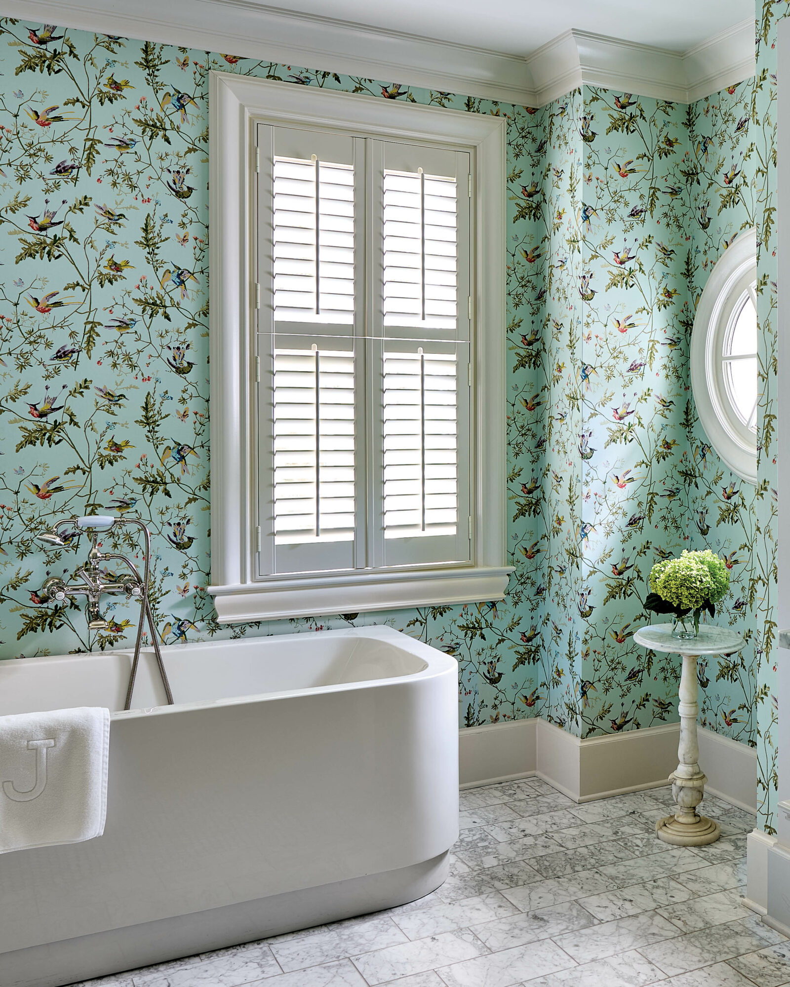 mint green floral wallpapered bathroom