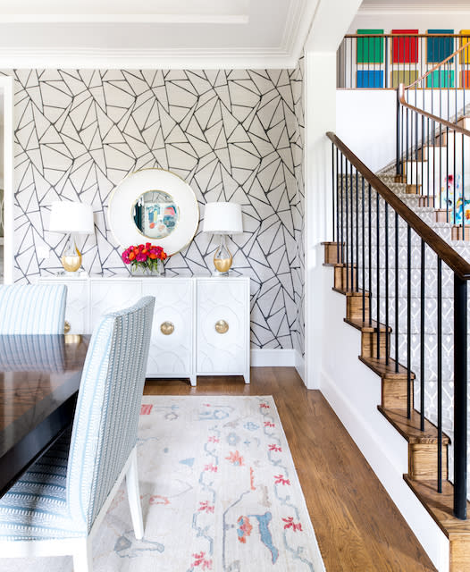 Dining area featuring staircase and wallpapered wall