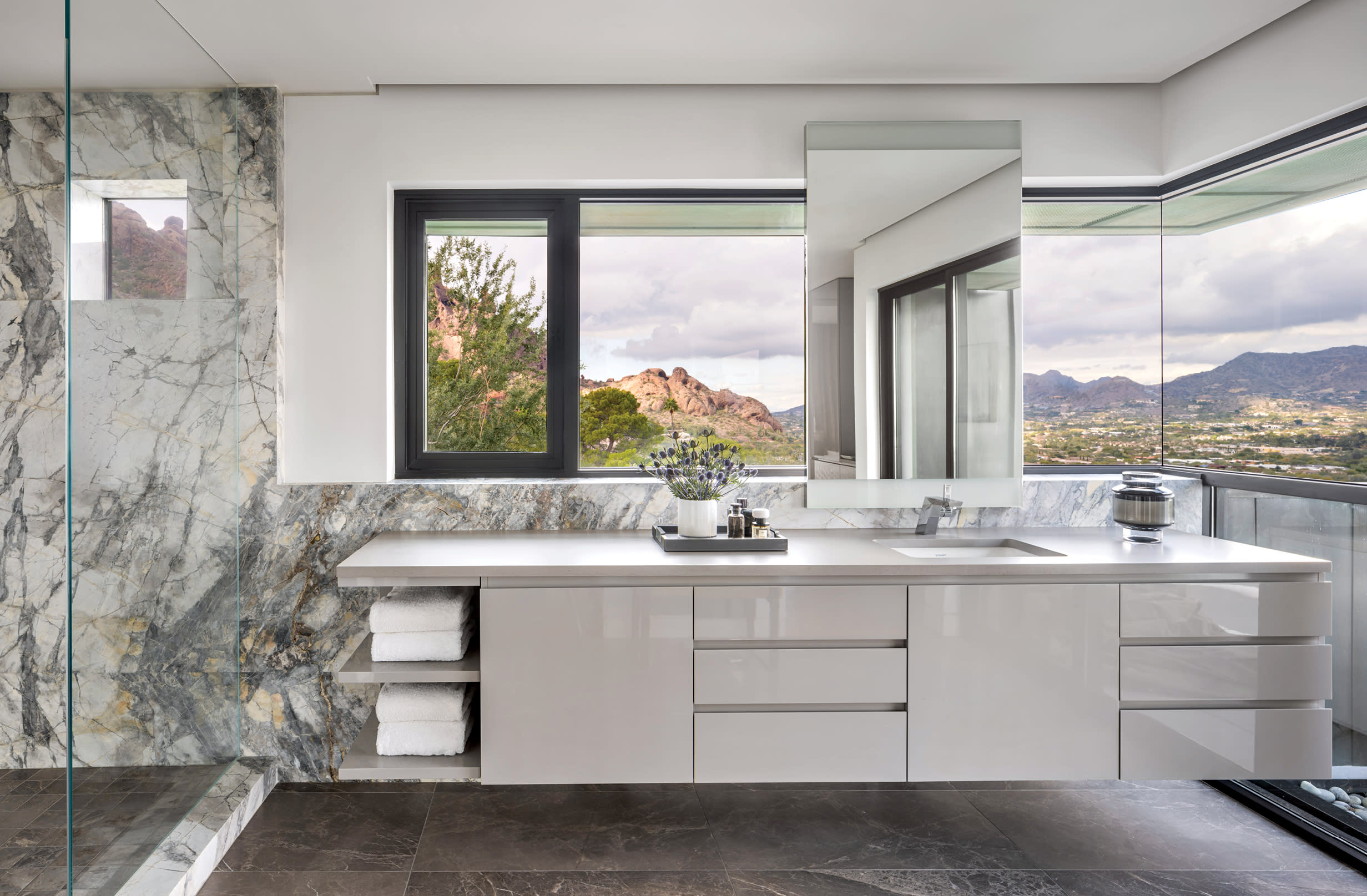 Patagonia quartzite wraps a luxurious bathroom with views of Arizona mountains