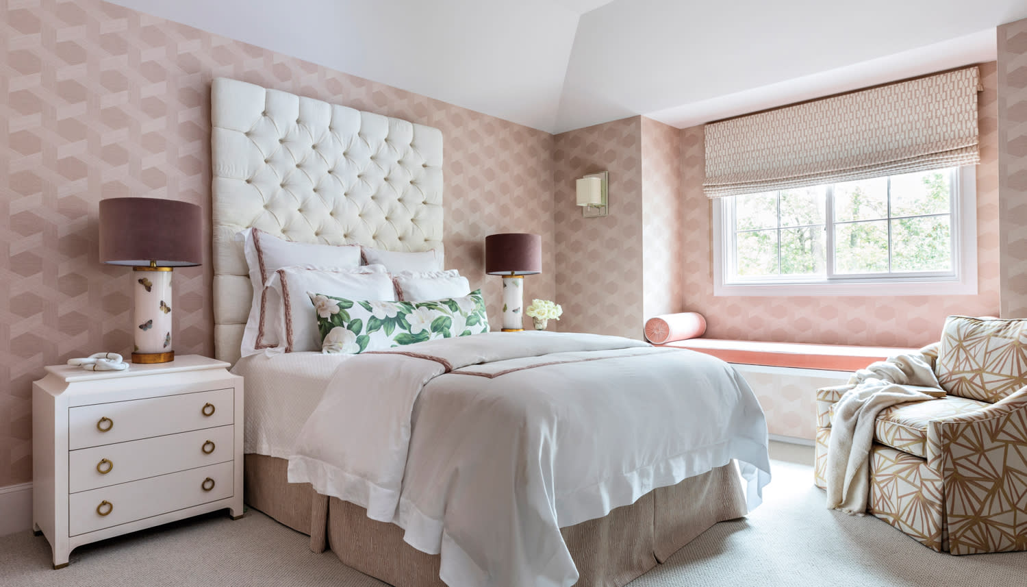 guest bedroom with petal-pink wallpaper and cloud-like bedding