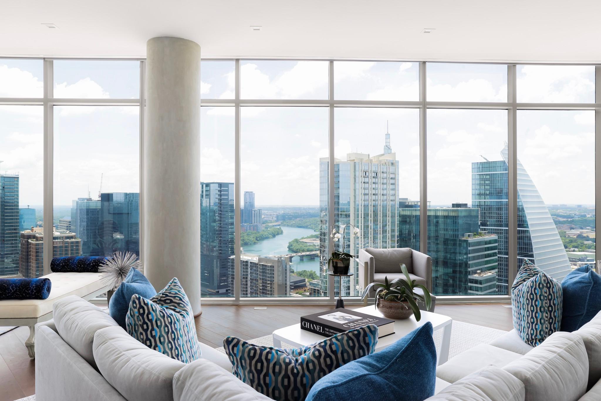 With breathtaking views of downtown Austin, this modern condo features floor-to-ceiling windows, bold geometric decor, and a vibrant blue color palette, creating a dynamic and airy living space. 
Photography by Brian Cole.