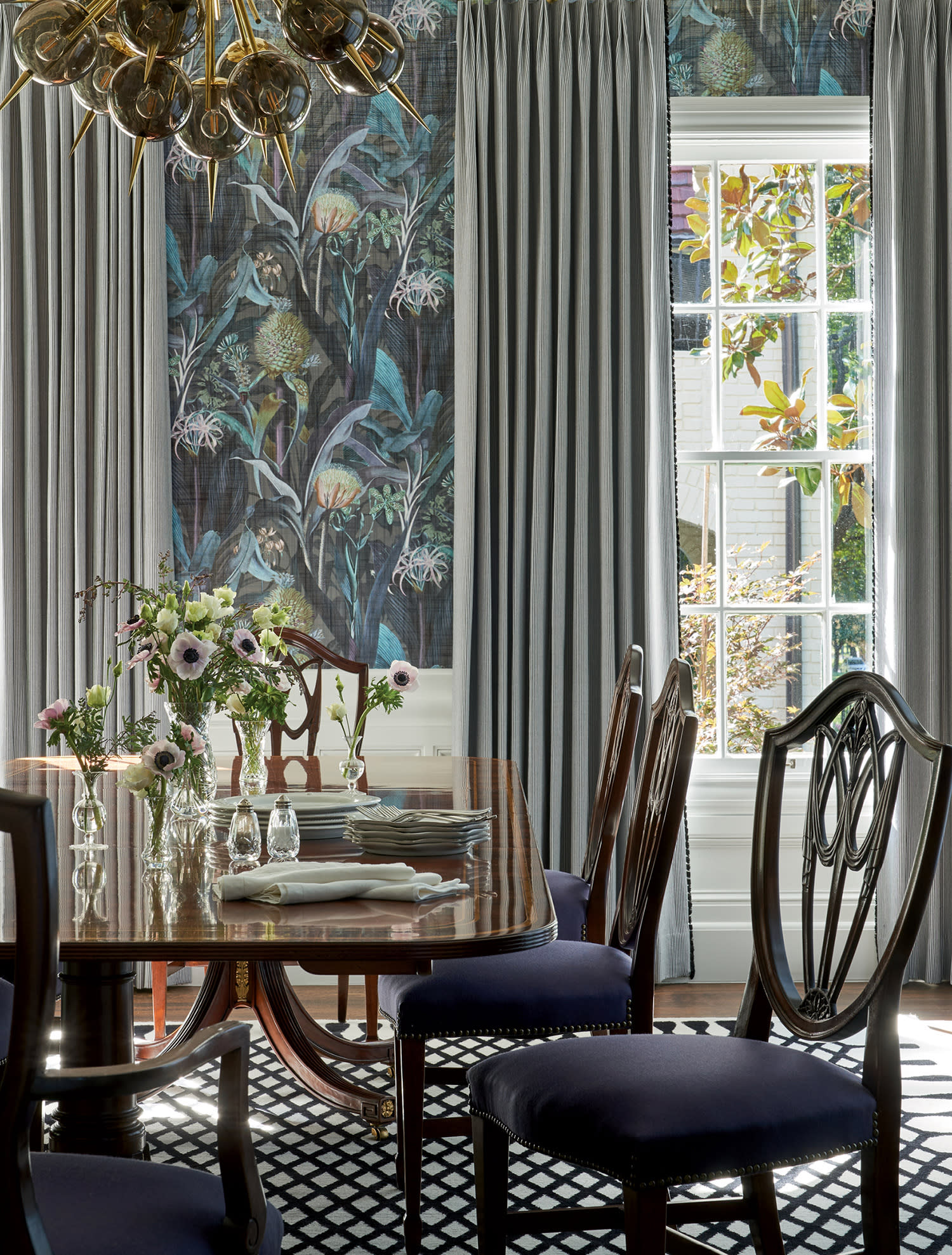 modern dining room with a moody floral wallpaper