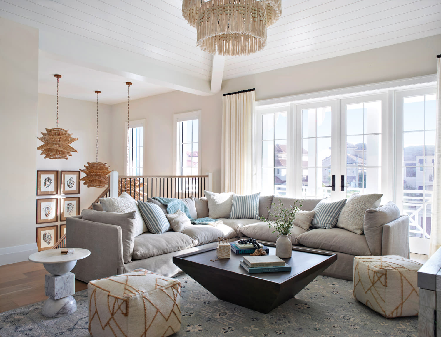 airy loft with a large sectional and coastal elegant furnishings