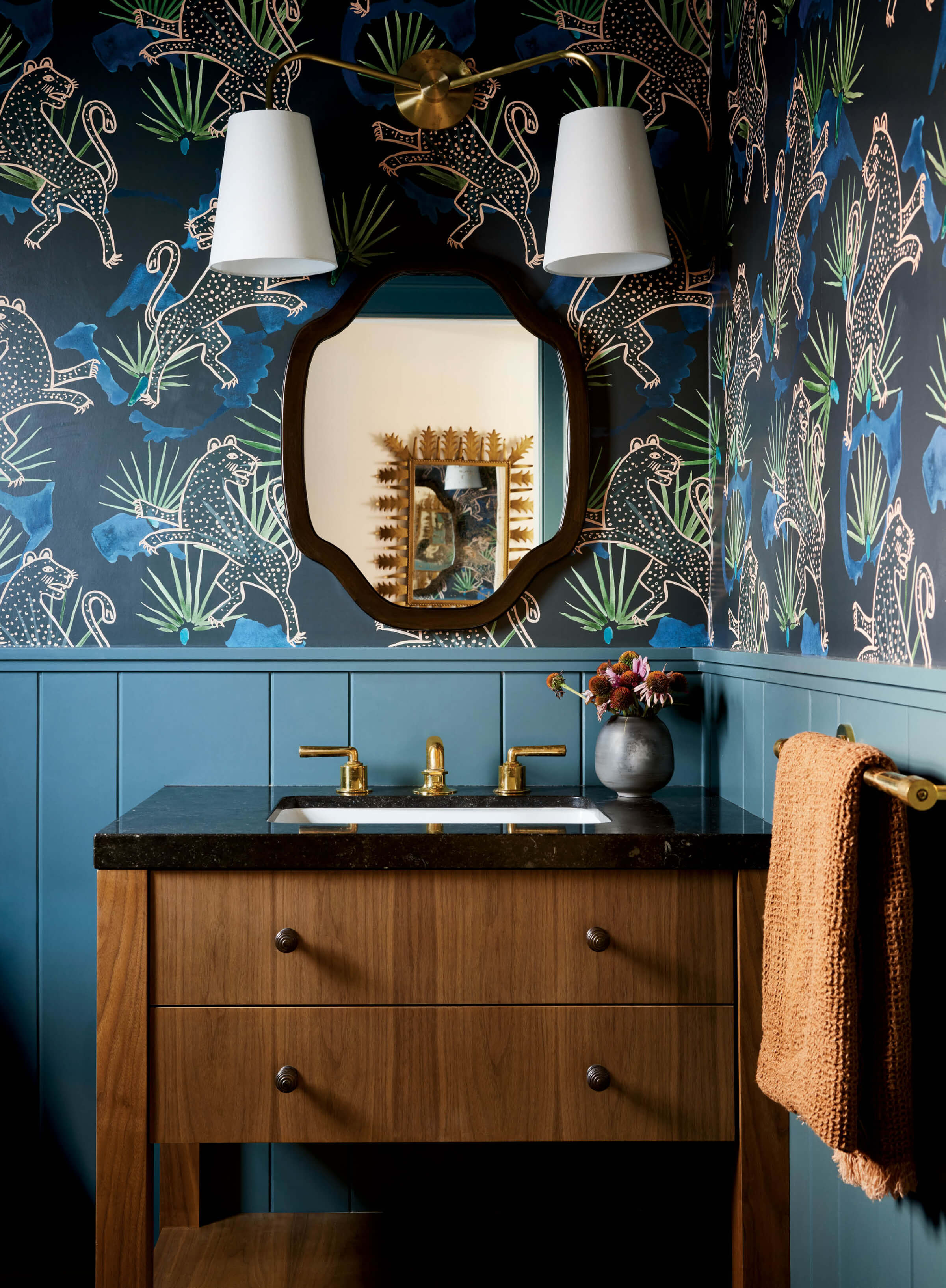 blue powder bath with Leopard Palm wallpaper and wood vanity