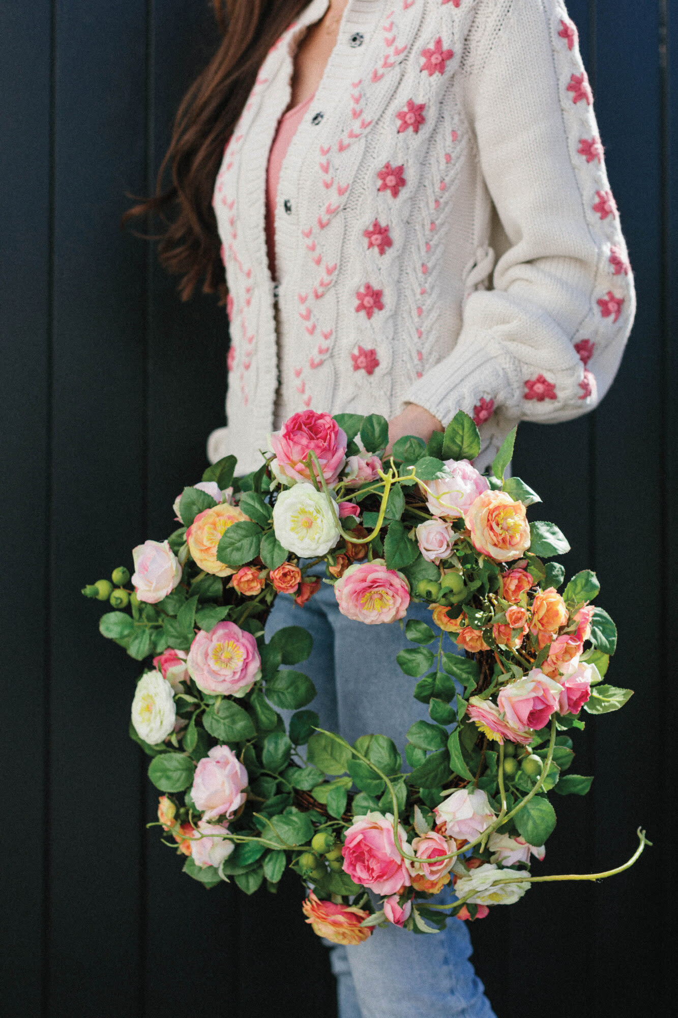 woman holding floral wreath