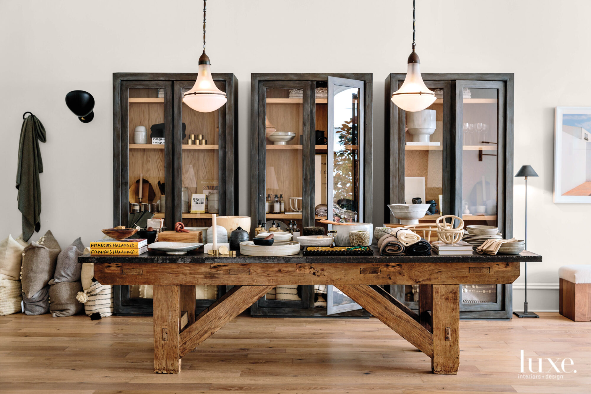 A long table is topped by various objects for sale.
