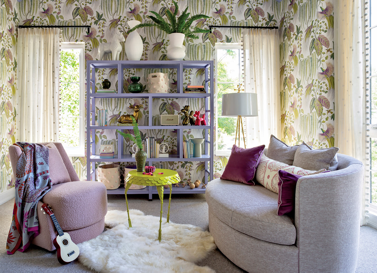 child's bedroom with floral wallpaper and purple furnishings