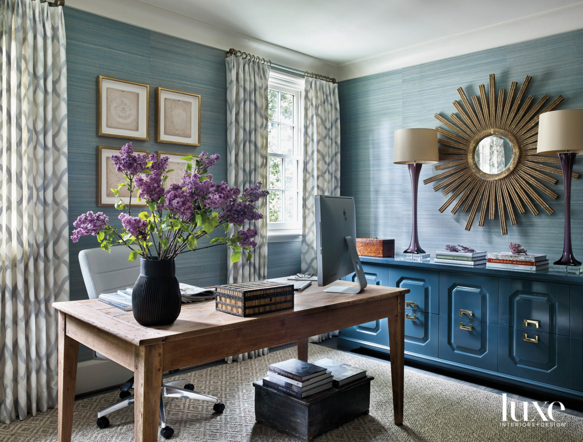 colorful blue office with wooden desk and purple flowers