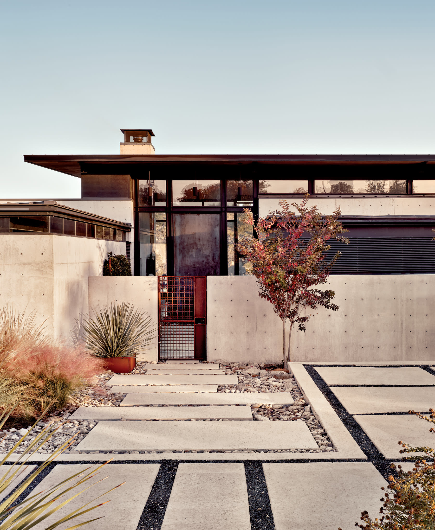 concrete landscaping in front of a Brutalist home in Texas