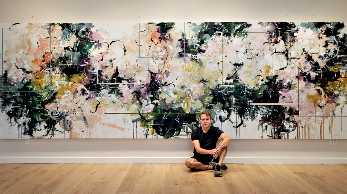 Carlos Ramirez in front of his artwork