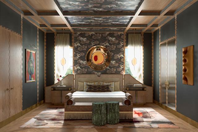 Luxurious bedroom with ornate ceiling, patterned walls, and opulent decor. A central bed is flanked by side tables. Large round gold mirror above.