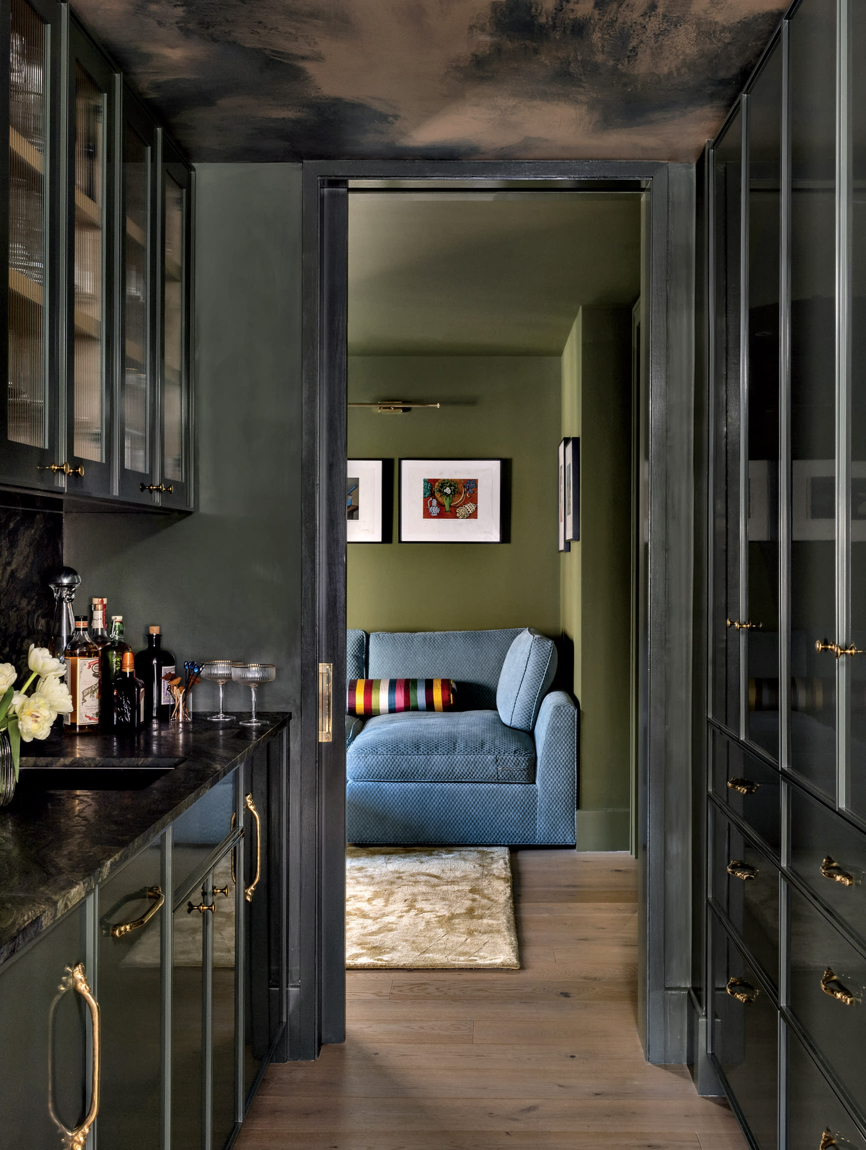 moody home bar with dark green cabinetry