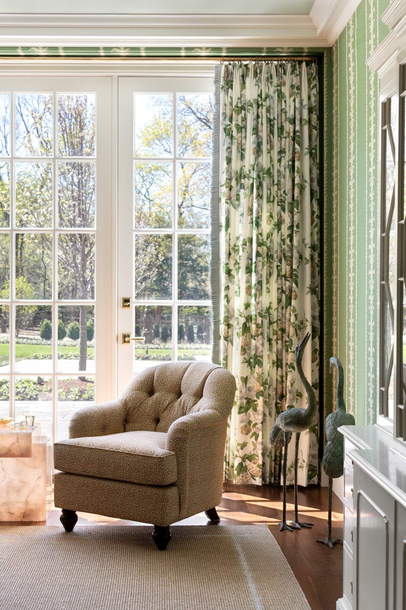 corner of room with armchair and green curtains