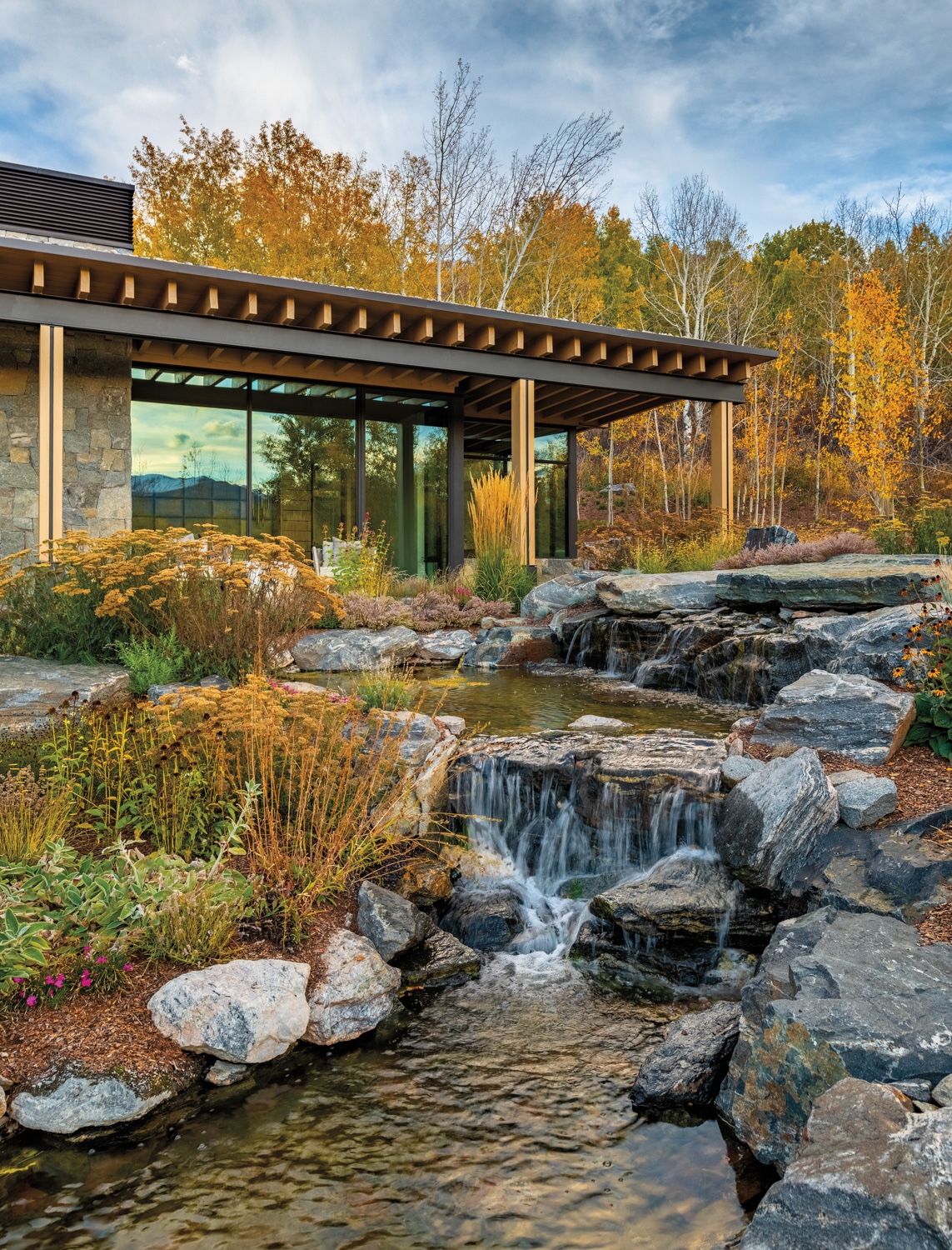 Exterior of the house with water feature that imitates the appearance of a natural mountain waterfall