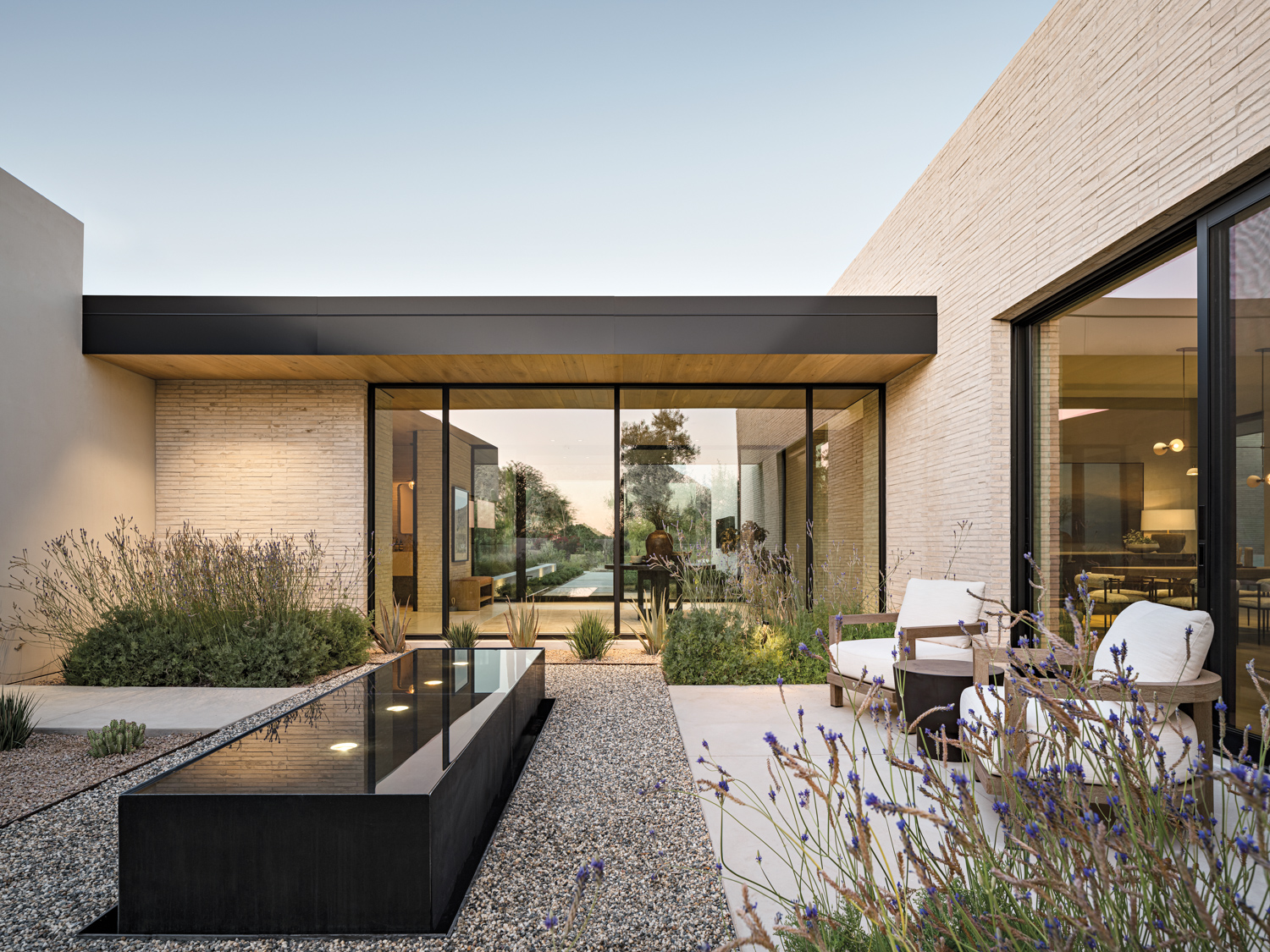 courtyard with pebble ground and a large black fountain