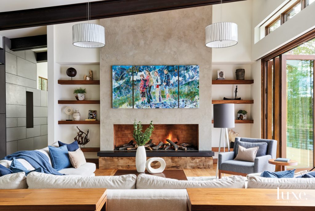 living room with abstract art over fireplace