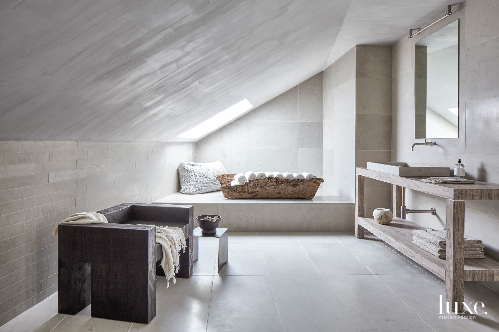 spa bathroom with custom wood vanity and limestone sink