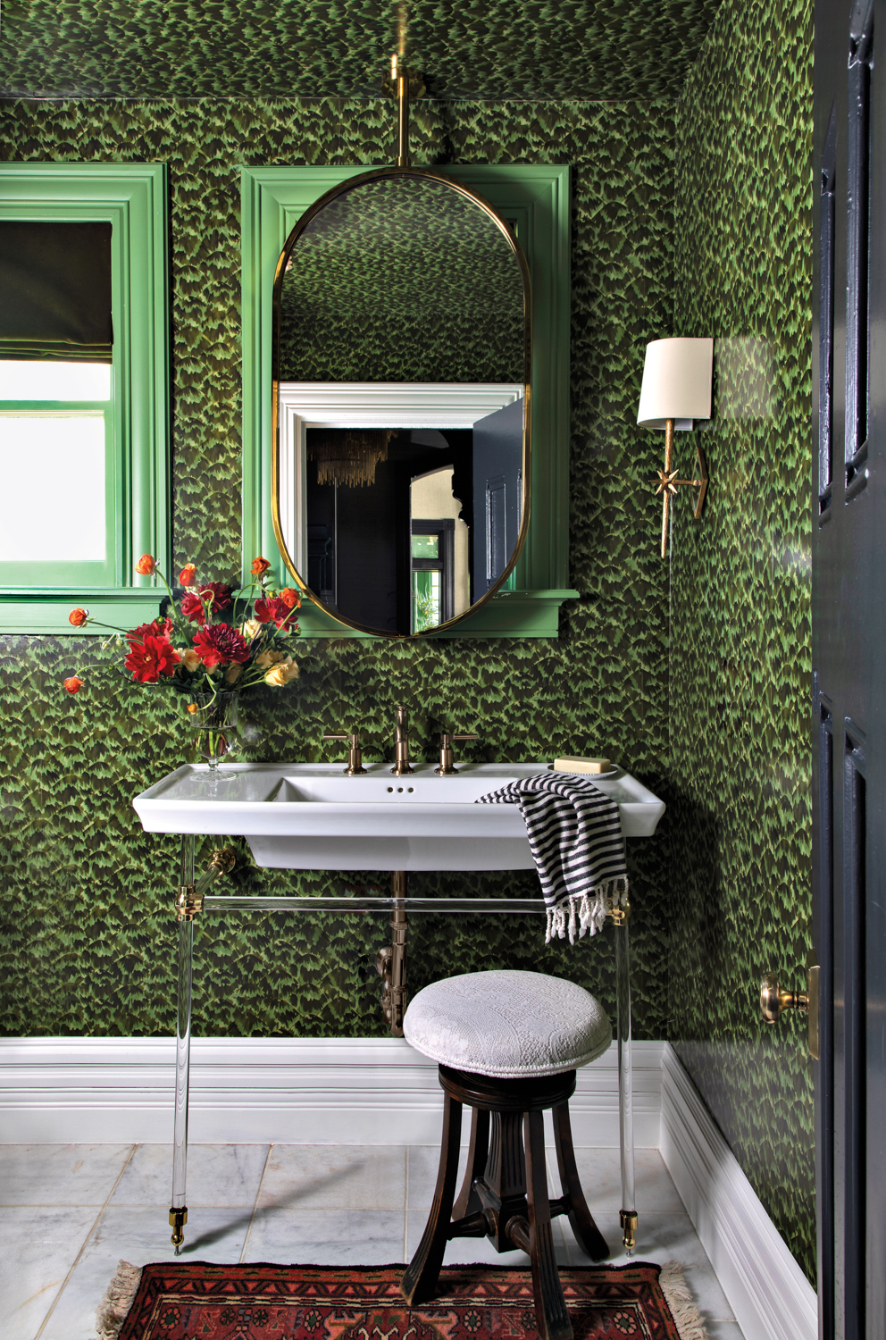 green bathroom with a leaf-like wall covering