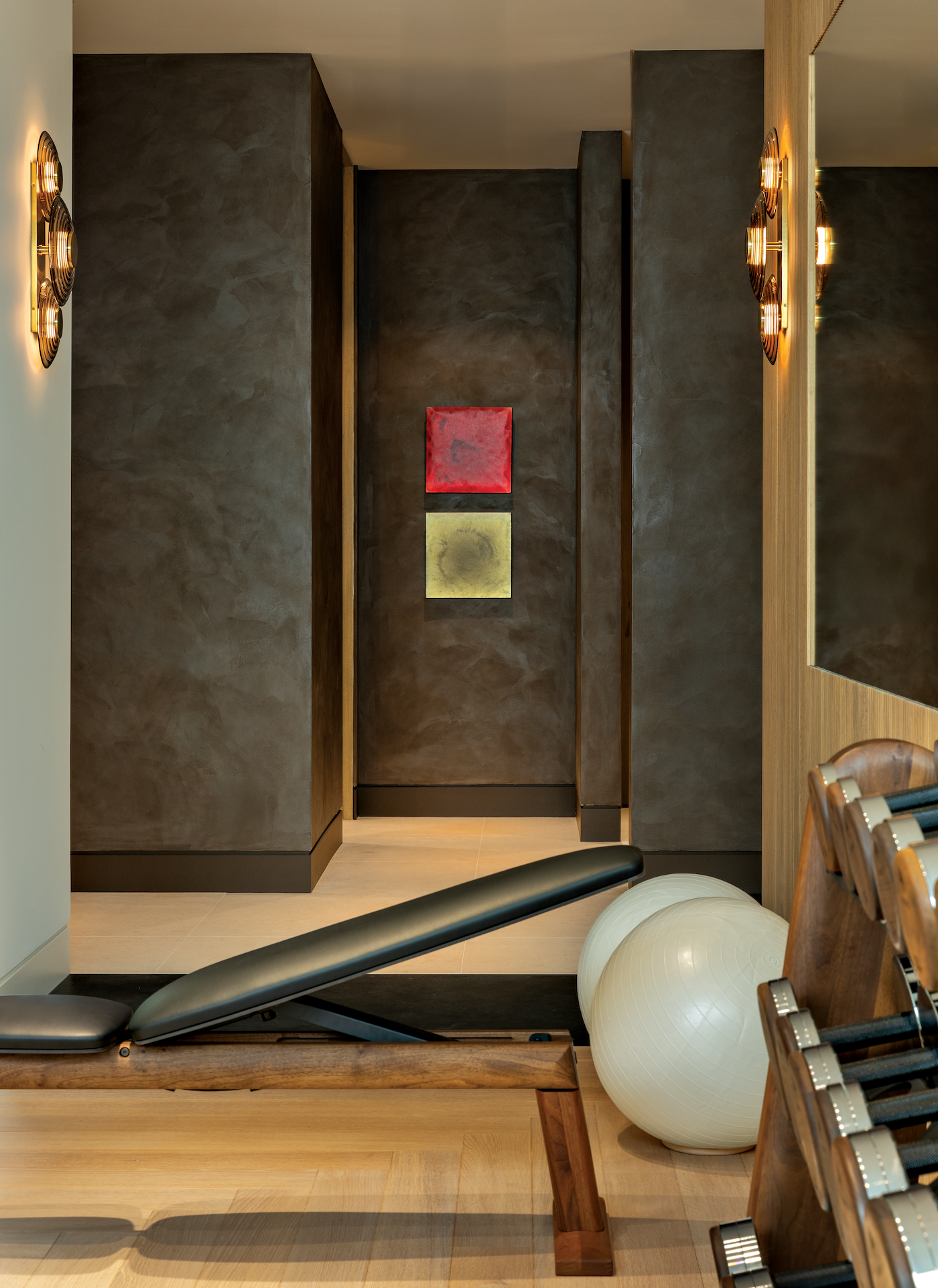 Textured dark gray wall displaying contemporary resin artwork in a moody interior setting.