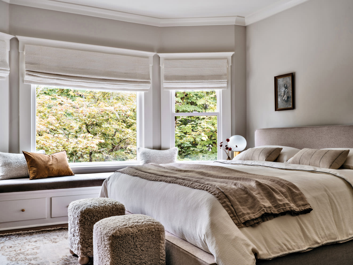 traditional neutral bedroom with a large window seat