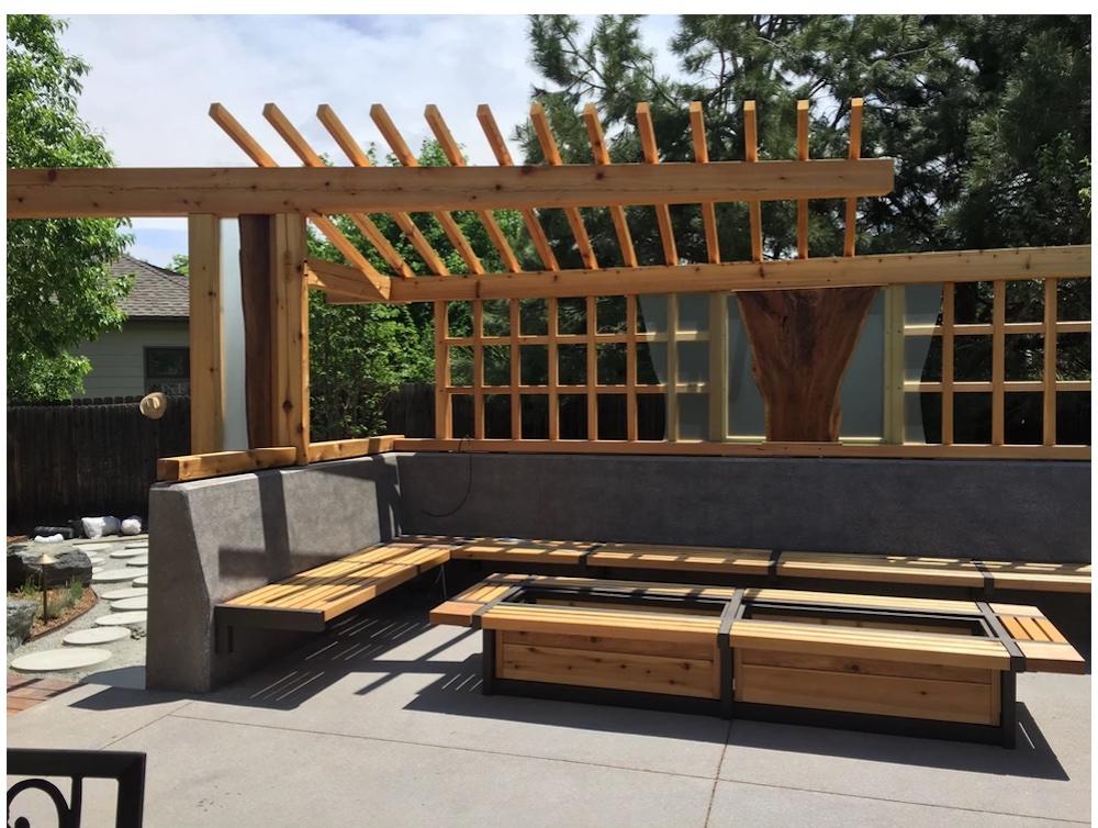 Outdoor deck with wood pergola, wooden benches and tables.