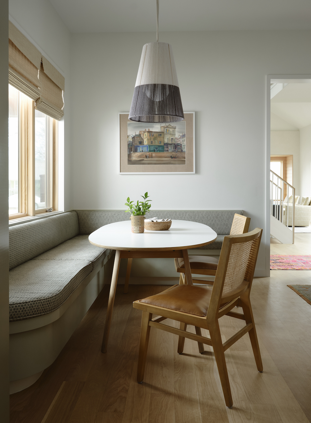 A casual breakfast nook features an expanding table and moveable light fixture.