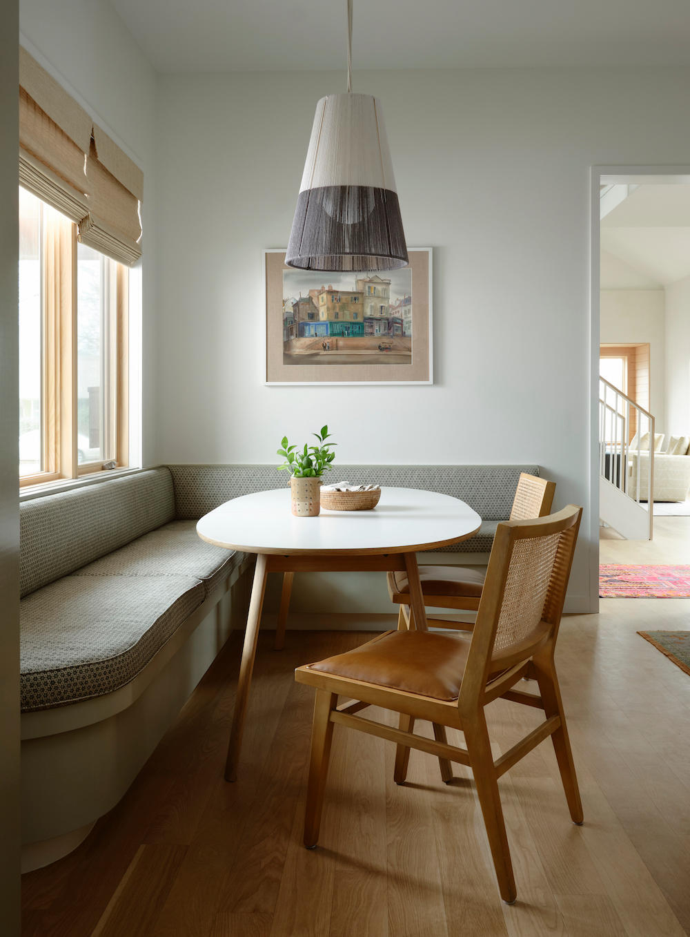 A casual breakfast nook features an expanding table and moveable light fixture.