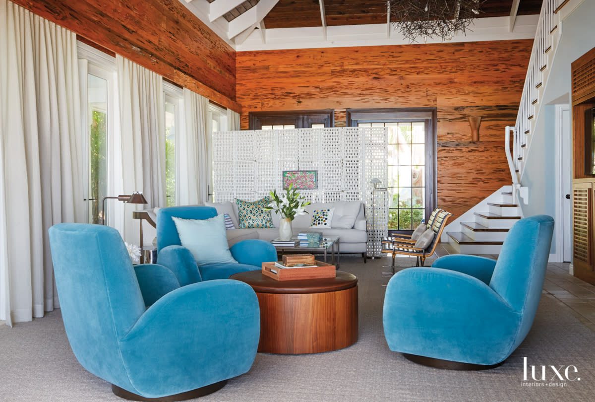 living room with high ceilings and swivel barrel chairs