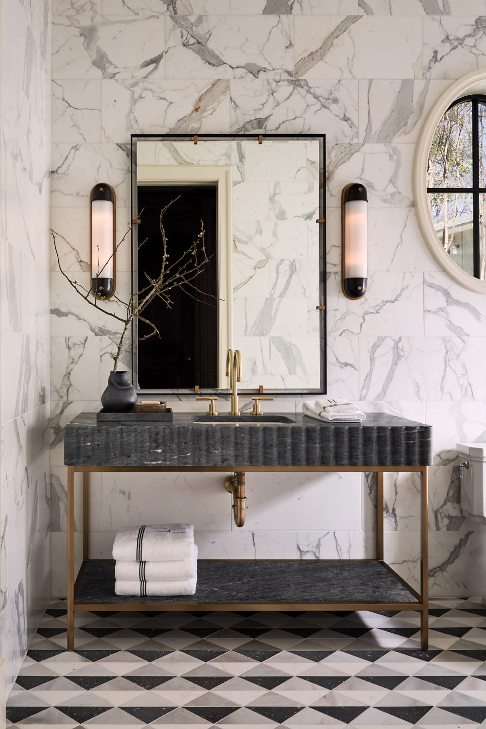 bathroom with marble walls, geometric pattern flooring and a black vanity