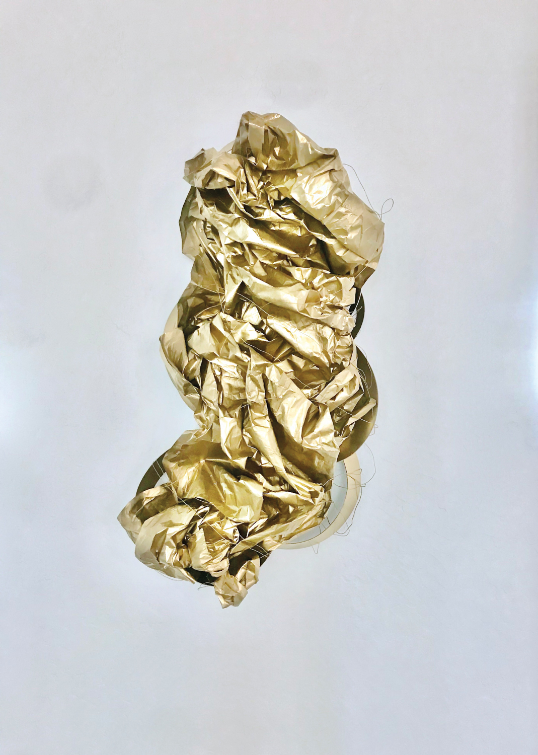 Mixed media gold artwork set against a white canvas