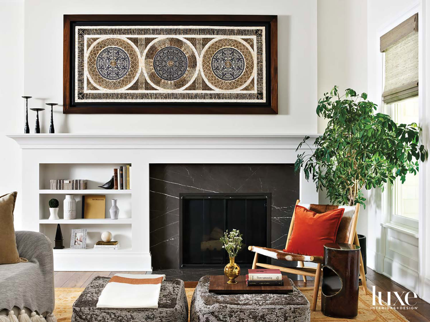 transitional living room with black stone fireplace and white mantle